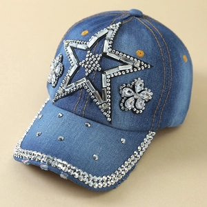 Close-up of denim baseball cap featuring rhinestone star and floral crystal decorations