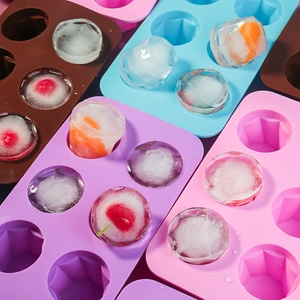 Detail of colorful silicone ice cube trays with fruit inside geometric diamond shapes
