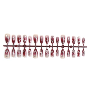 Red ombre almond press-on nails with silver metallic heart and moon star patterns