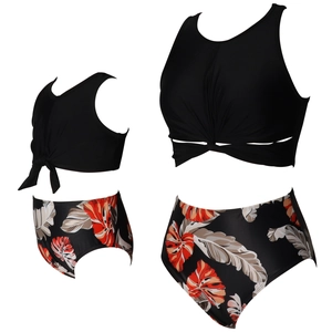 Detail of high-waisted bikini with tropical leaf print and twist knot black top for family