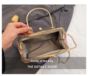 Macro detail of purple velvet evening bag interior with gold clasp and chain strap