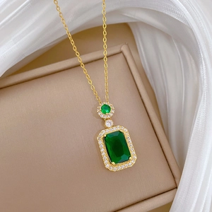 Detailed macro shot of an emerald green rectangular pendant with white zircon inlays
