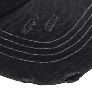 Detail of distressed brim on black cotton baseball cap with four rows of stitching