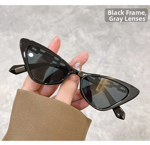 Detailed close-up of retro cat-eye sunglasses with unique black chain temple design