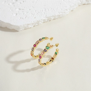 Detailed close-up of 14K gold plated hoop earrings with vibrant colorful gemstones