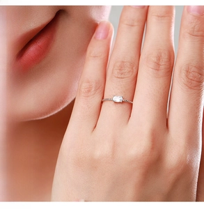 Detail of S925 sterling silver twist ring featuring an oval clear gemstone on finger
