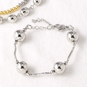 Polished silver beaded bracelet with spiral metal bars and adjustable clasp for women