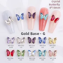 Close-up of crystal butterfly nail charms with gold metal base in ten vibrant colors
