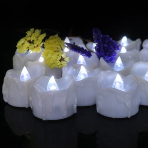 Cold white LED flameless tea lights with wax-drop design and purple floral decor