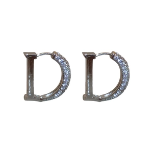 Silver metal D-letter earrings with shimmering zircons in a minimalist luxury style