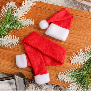 Miniature red and white felt Christmas hat and scarf set on a festive wooden surface