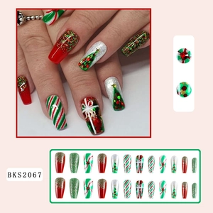 Detailed view of Christmas press-on nails featuring red, green, and white festive patterns