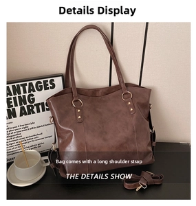 Detail view of brown large tote bag with adjustable long shoulder strap and gold hardware