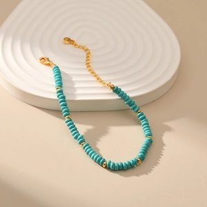 Bohemian turquoise beaded bracelet with gold accents and adjustable chain extension
