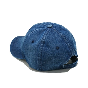 Detail view of washed denim baseball cap back with adjustable strap and vintage texture