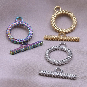 Macro detail of leaf textured stainless steel OT clasps in gold, silver, and rainbow tones