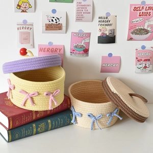 Handwoven cotton rope storage basket with lid and bow for home desktop organizing