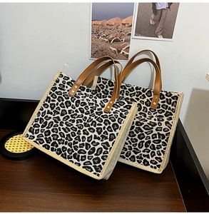 Detail of leopard print linen tote bags featuring vintage PU leather handles and metal rivets