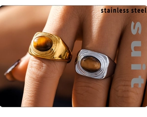 Macro shot of oval tiger eye stone inlay on a vintage texture gold stainless steel ring