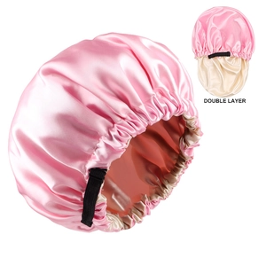 Detail view of pink double layer satin bonnet with adjustable buckle and elastic band