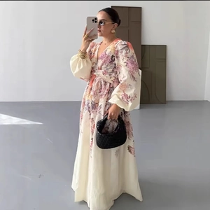 Floral V-neck maxi dress with long puff sleeves and elegant cream and purple flower print