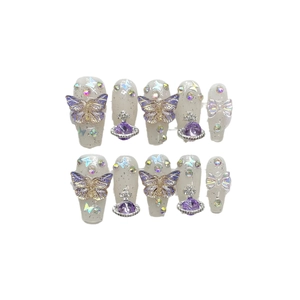 Handmade press-on nails with purple glitter 3D butterflies and Saturn planet charms