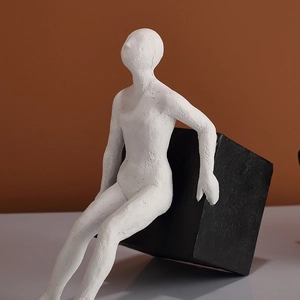 Modern abstract resin figure sculpture with black cube bookend for office shelf decor