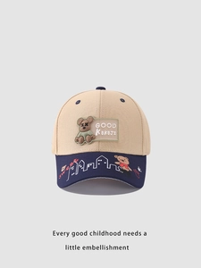 Detail of baby baseball cap featuring 3D cartoon bear patch and bicolor cotton twill