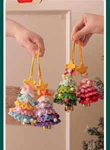 Handcrafted crochet Christmas tree ornament with colorful pom-poms and a metal bell