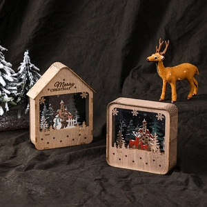 Illuminated wooden Christmas house ornament with snowman and reindeer laser-cut scenes