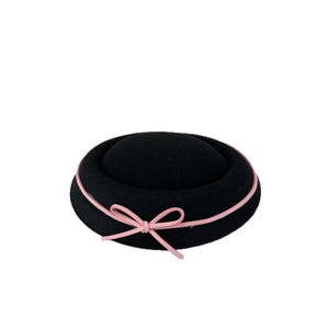 Elegant black wool pillbox hat for women with a delicate pink velvet bow accent
