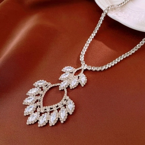 Macro detail of luxury teardrop pendant with micro-pave zircon and marquise-cut crystals
