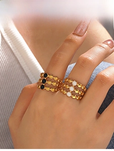 Close-up of a 3-layer 18K gold plated stainless steel ring with black and white accents