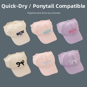 Detail of multi-color baseball caps with ponytail holes and Boston 1930 embroidery