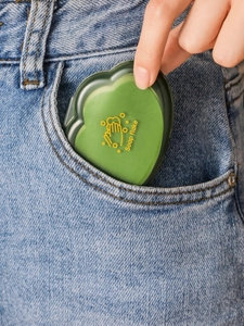 Green heart-shaped soap flake box shown being easily tucked into a denim pocket