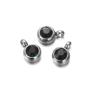 Three round green zircon pendants with silver stainless steel bezels and hanging loops