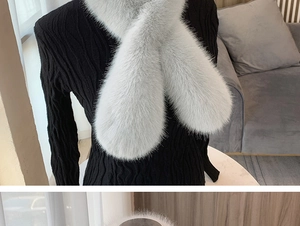 Close-up of light gray faux fur scarf texture showing dense plush fibers on a sweater