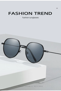 Detail shot of vintage black oval sunglasses with thin metal frames on white display
