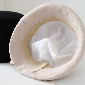 Minimalist cotton-linen sun bucket hat with breathable lining and adjustable strap detail