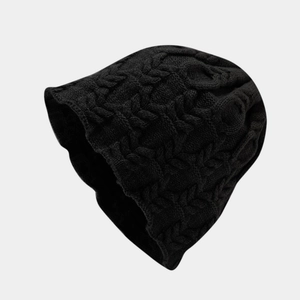 Close-up of black cable-knit texture on a loose oversized winter beanie hat