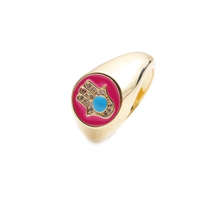 Detail of gold Hamsa ring with pink enamel background and center blue gemstone inlay