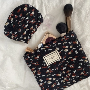 Detail of floral chiffon makeup bag set with pleated texture and floral patterns