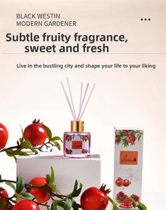 Detailed pomegranate reed diffuser set with glass bottle and decorative packaging box