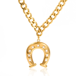 Close-up of gold chunky chain necklace with crystal-studded horseshoe pendant