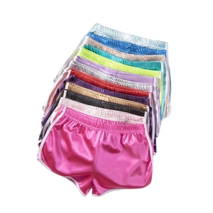 Detailed stack of colorful satin sports shorts with white trim and elastic waistbands
