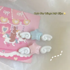 Cute star hair clips with white wings in pink and blue colors on a sweet background