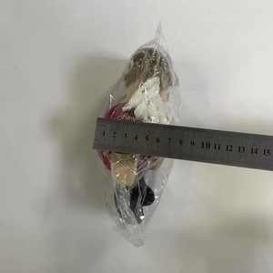 Detailed measurement of plush Christmas ornament showing width of approximately 13cm