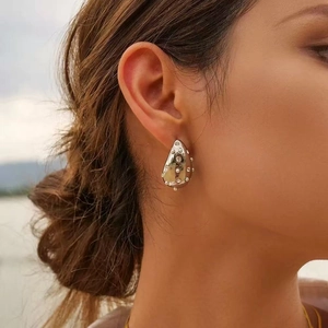 Silver teardrop earrings with zircons on model showing elegant minimalist design