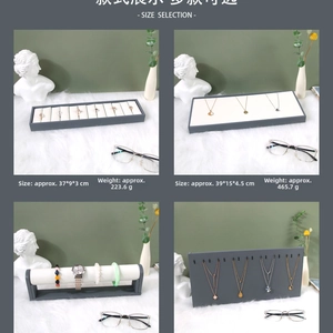 Detailed views of grey PU and white velvet jewelry display trays for rings and necklaces