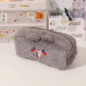 Macro detail of plush pencil case featuring soft faux fur texture and cute embroidery